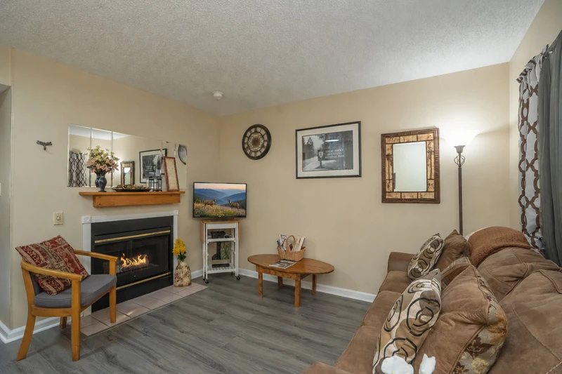 Settle into this welcoming living area where a cozy fireplace creates the perfect ambiance for your mountain getaway. Sink into the plush sofa with your favorite book or gather with loved ones for memorable evenings.