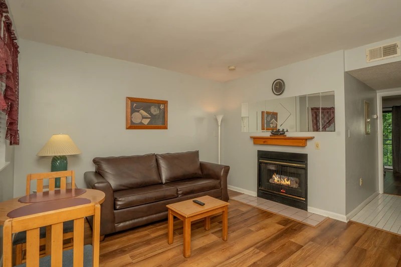 Sink into the plush leather sofa after your day's adventures, with warm firelight and peaceful views creating your perfect mountain retreat.